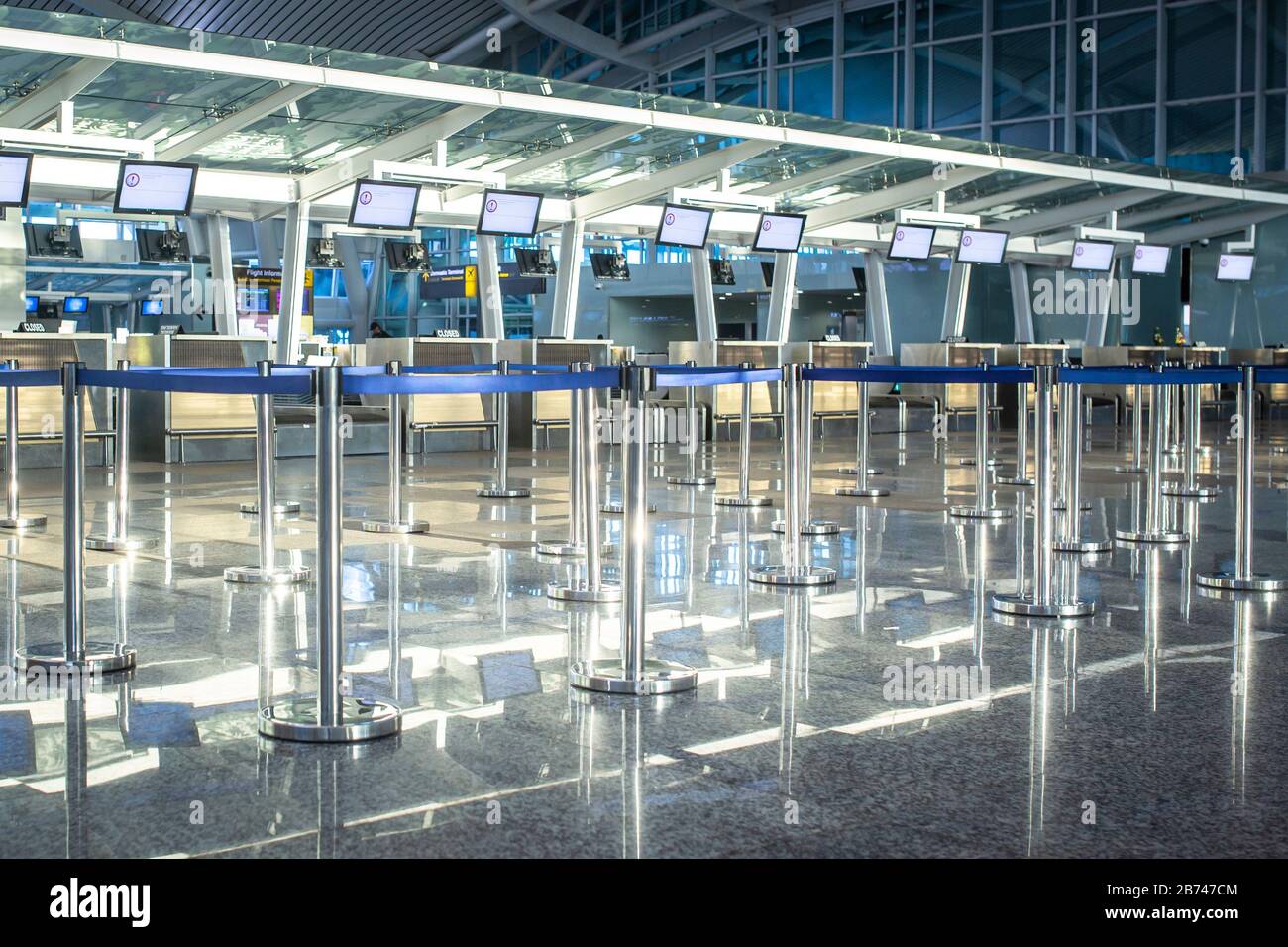 Empty check-in desks at the airport terminal. Stock Photo