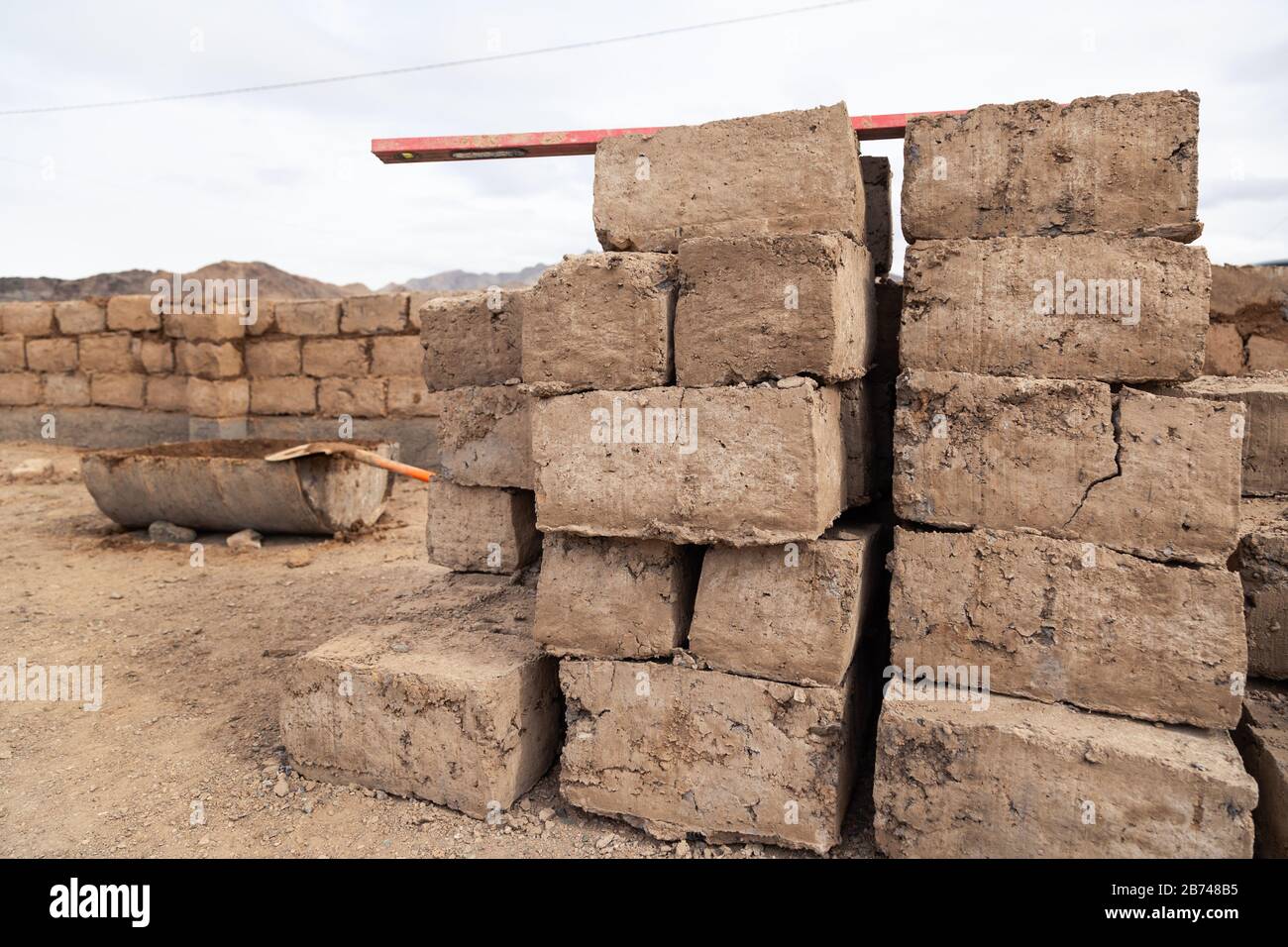 Traditional homemade production of raw clay brick laid out in stacks