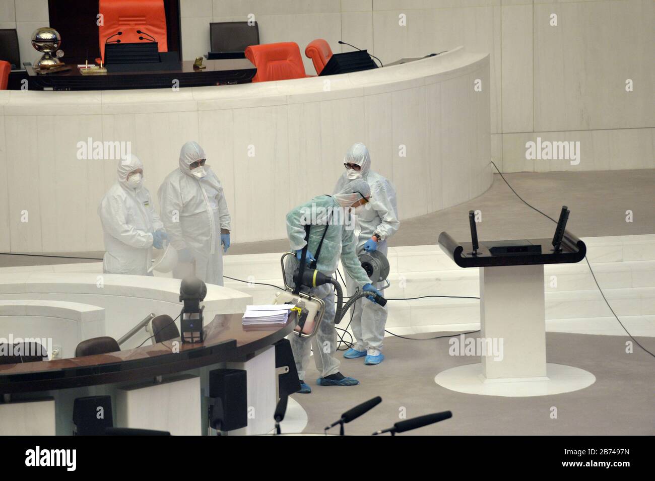Ankara, Turkey. 13th Mar, 2020. Staff members spray disinfectant at the parliament in Ankara, Turkey, March 13, 2020. Turkish Health Minister Fahrettin Koca announced on Friday that the second patient has been diagnosed with COVID-19 in Turkey. Credit: Mustafa Kaya/Xinhua/Alamy Live News Stock Photo