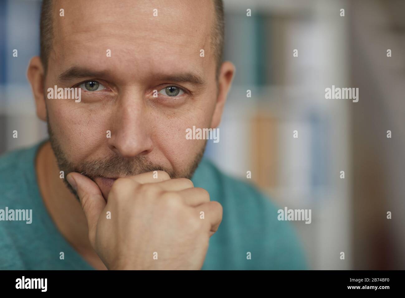 Portrait of handsome mature man looking at camera with pensive sight Stock Photo