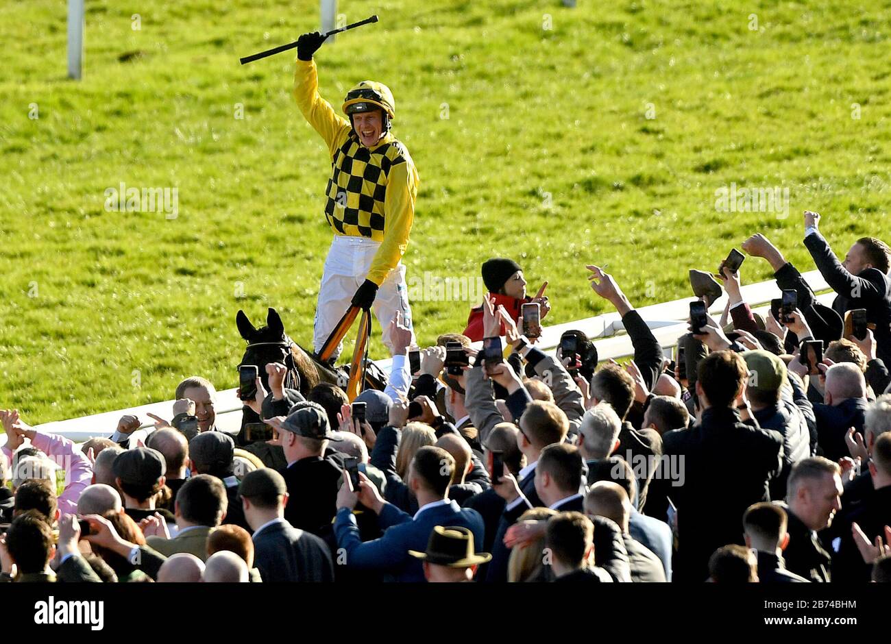 Jockey Paul Townend celebrates on Al Boum Photo after winning the Magners Cheltenham Gold Cup Chase during day four of the Cheltenham Festival at Cheltenham Racecourse. Stock Photo