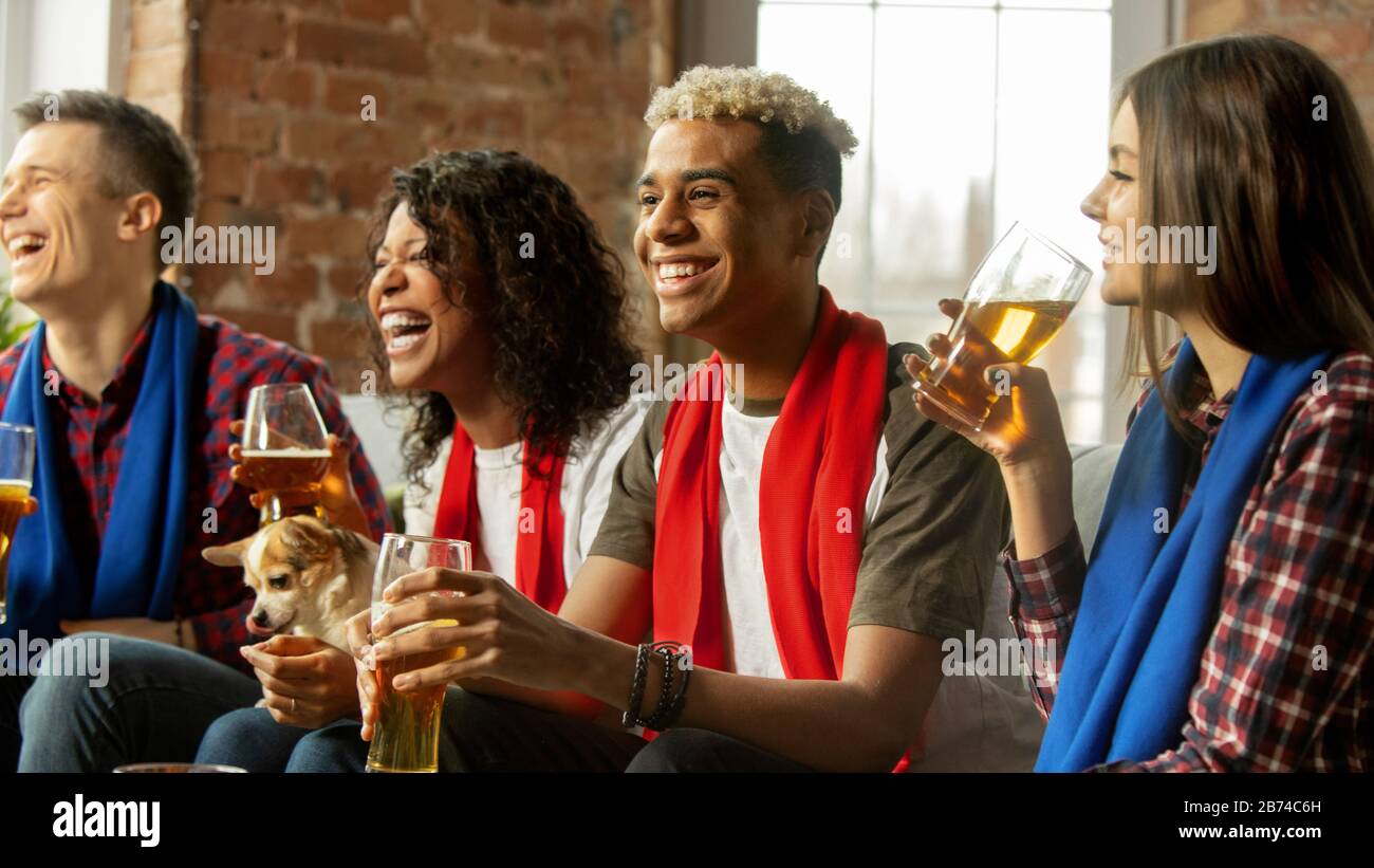 Winners. Excited people watching sport match, chsmpionship at home. Multiethnic group of friend, fans cheering for favourite national basketball, tennis, soccer, hockey team. Concept of emotions. Stock Photo