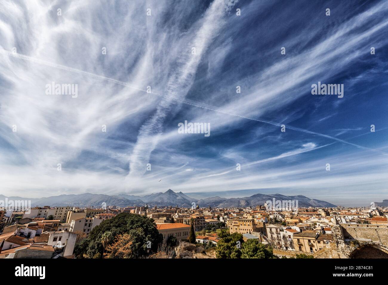 Geoengineering, chemtrails, weather control, HAARP, man-made cloud formations above Palermo city, Sicily, March 2020 Stock Photo