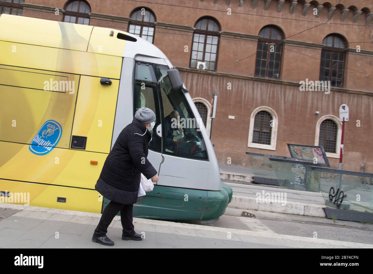 Roma, Italy. 13th Mar, 2020. Woman with antivirus mask at tram stop near Piazza Venezia in Rome after the Decree of the Italian Government 11 March 2020 (Photo by Matteo Nardone/Pacific Press) Credit: Pacific Press Agency/Alamy Live News Stock Photo