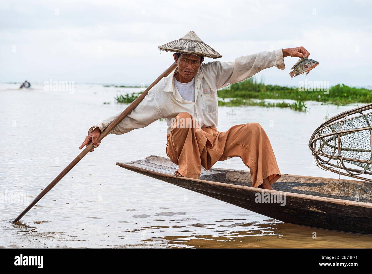 Inle lake: Myanmar - Asia. - 08-15-2019. The Intha fishermen of Inle Lake in Burma demonstrate their unusual technique for catching fish in the shallo Stock Photo