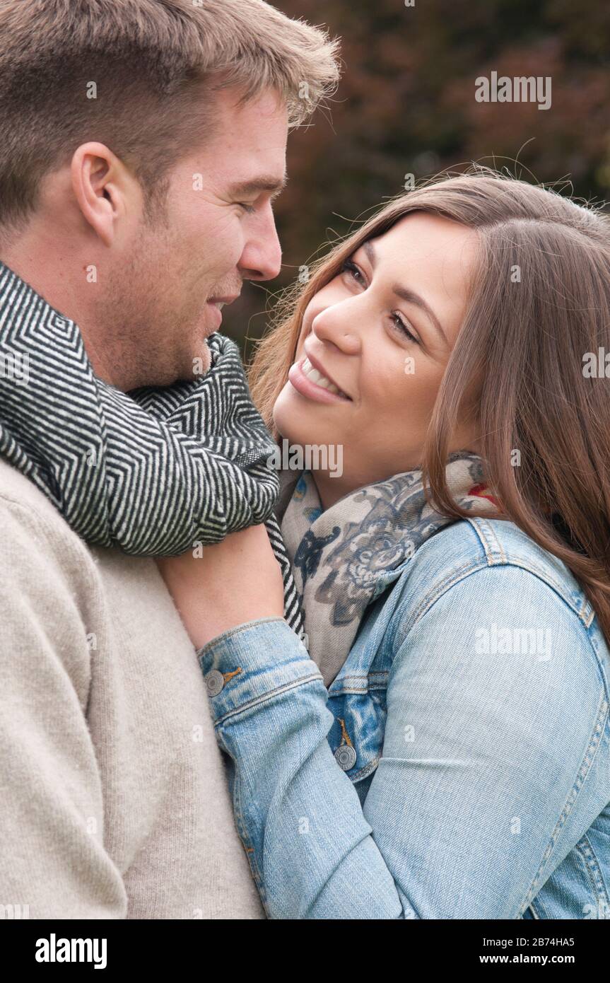 Young couple laughing and cuddling outdoors Stock Photo