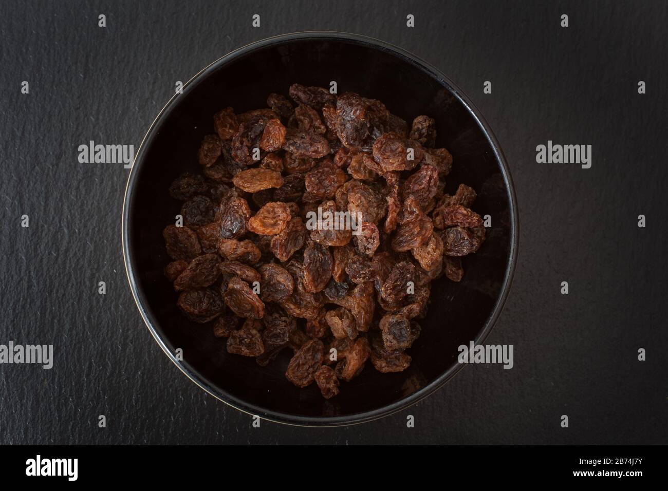 A studio photograph of a bowl of sultanas Stock Photo