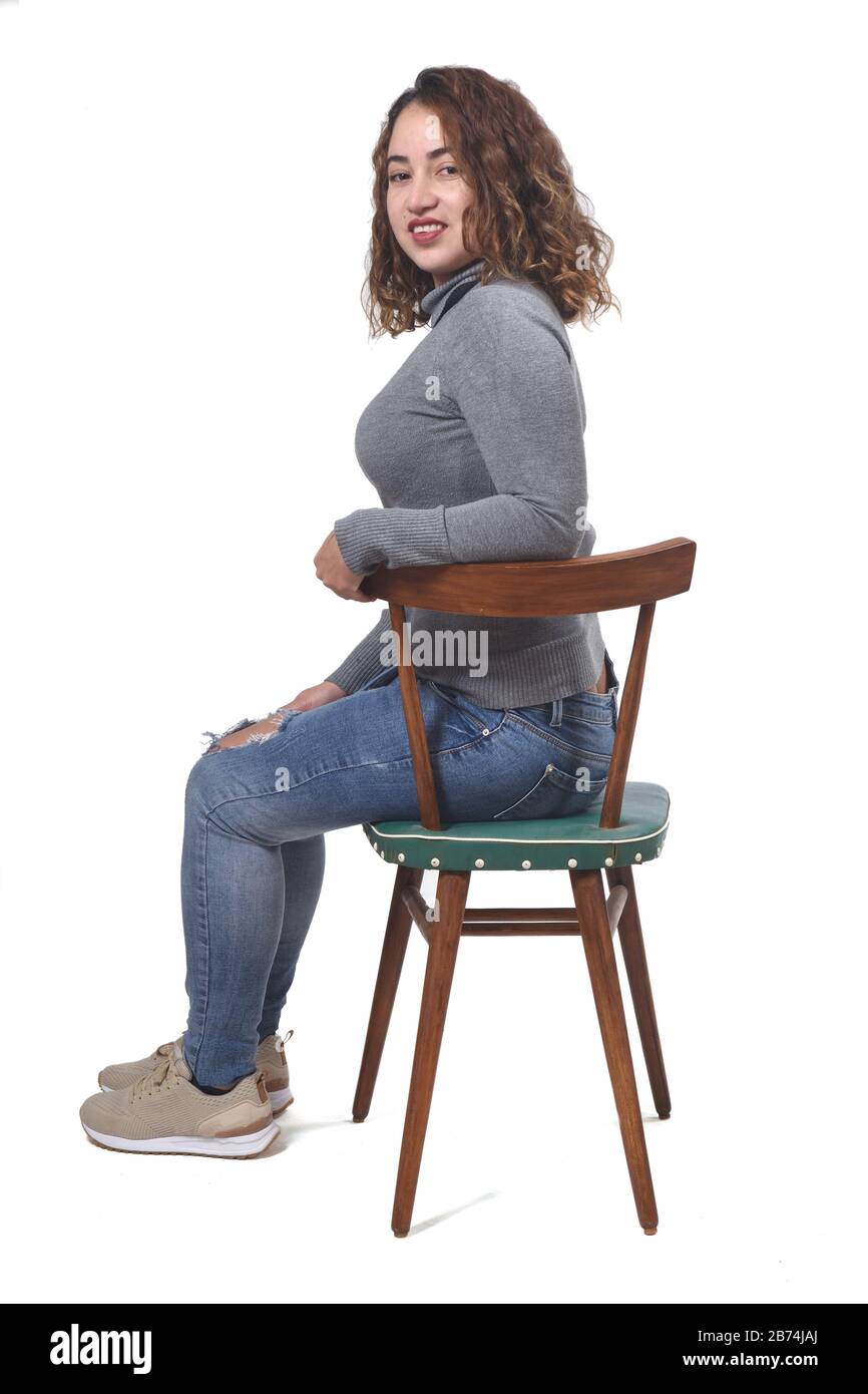 portrait of a woman sitting on a chair in white background Stock Photo ...