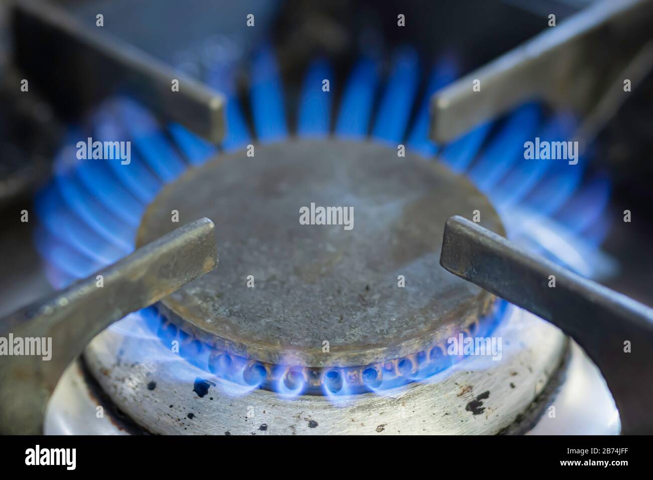 Close up image of gas flame burning on a domestic kitchen hob. Global warming issue.Rising energy prices in the UK.Fossil fuels.Climate change. Stock Photo