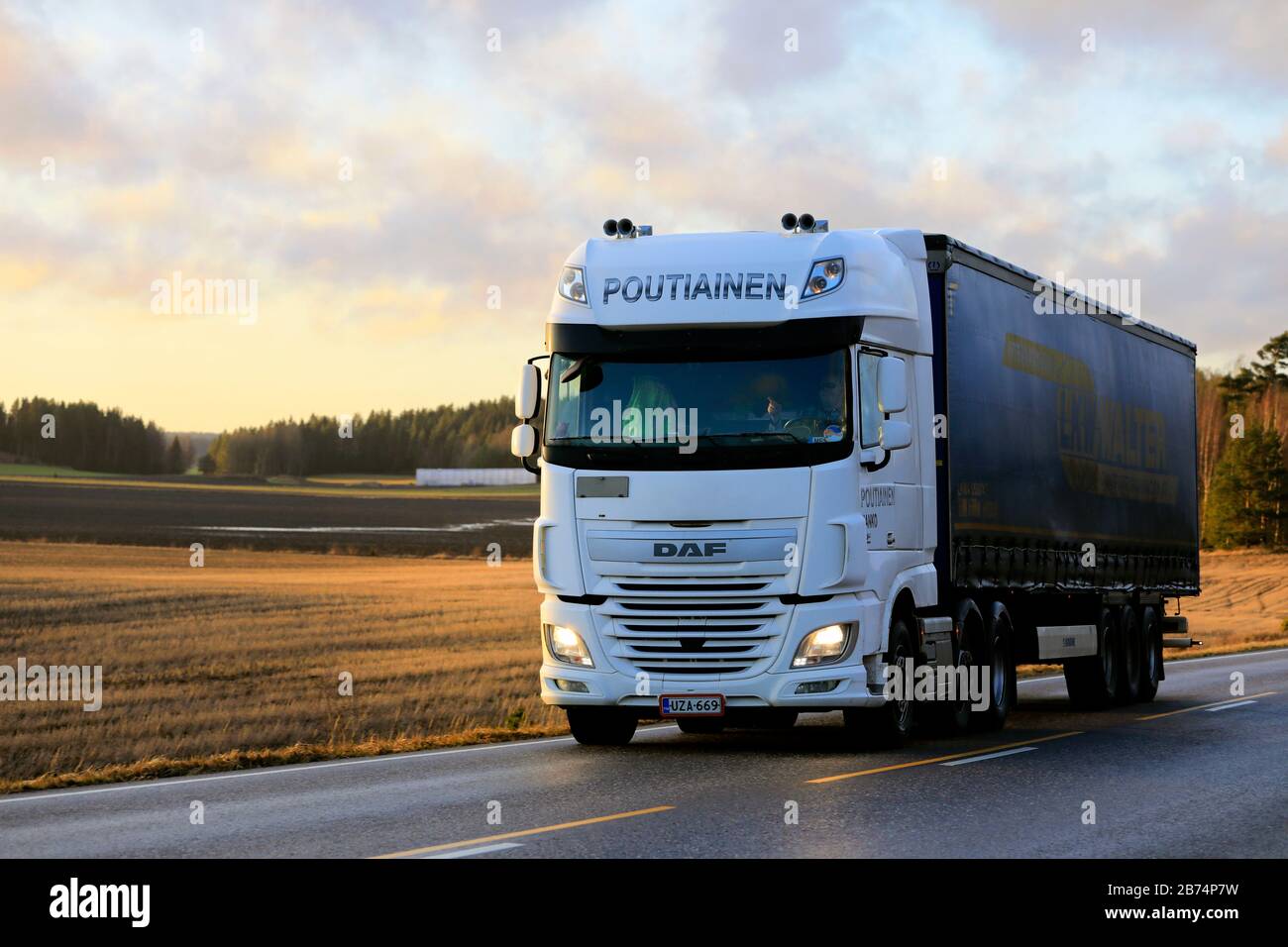 White DAF XF truck of Poutiainen pulls LKW Walter freight trailer on  highway 52 at sunset time in early spring. Salo, Finland. February 21, 2020  Stock Photo - Alamy