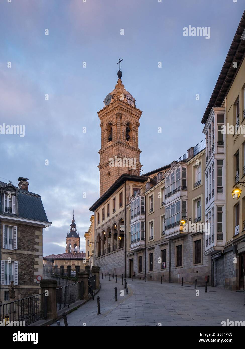 View of the tower of St. Vincent Church and Cuesta de San Vicente Street, in the back the tower of St. Michael Church in Vitoria-Gasteiz, Spain Stock Photo