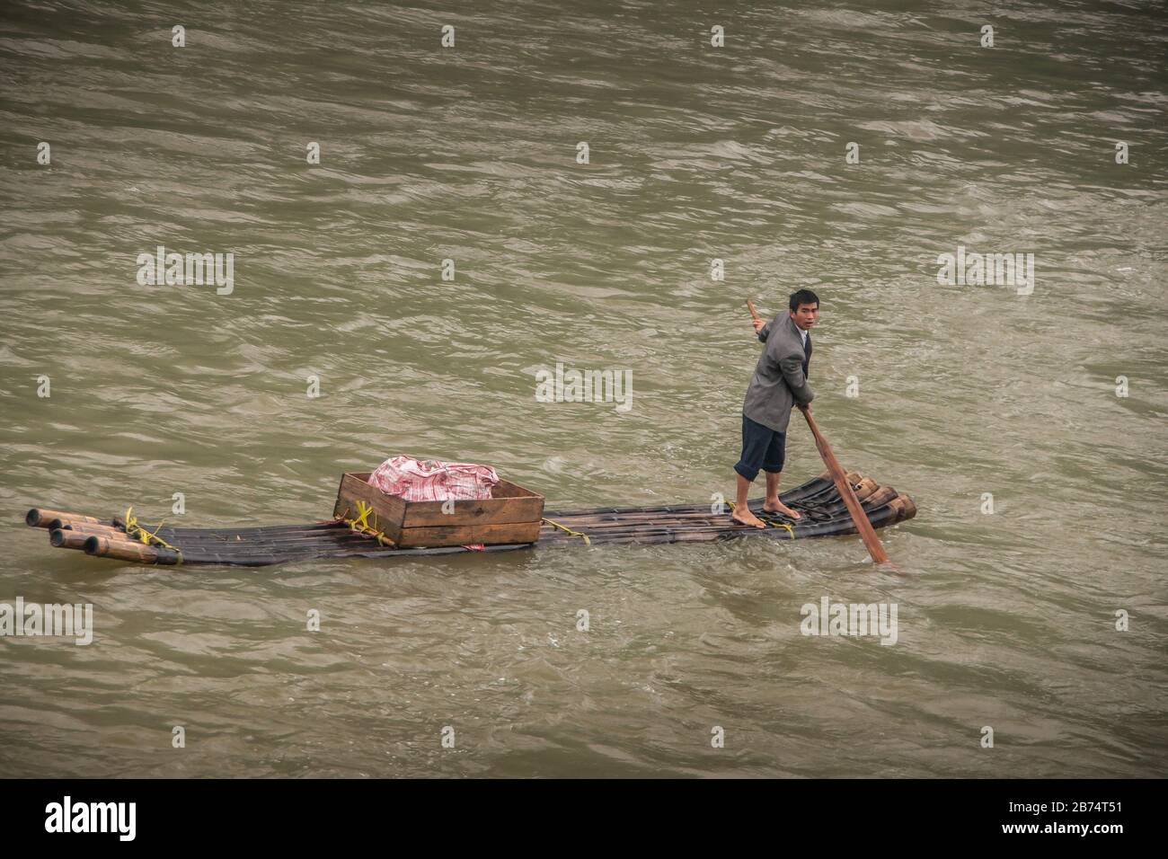 Guilin, China - May 10, 2010: On Li River. Closeup, Male vendor with ...