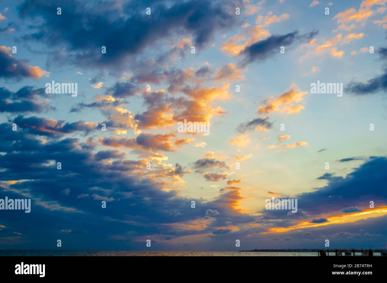 Beautiful sky with clouds over the sea at dawn. Natural background Stock Photo