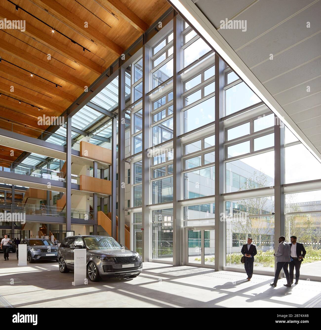 Central street with current car models and view to landscaped exterior