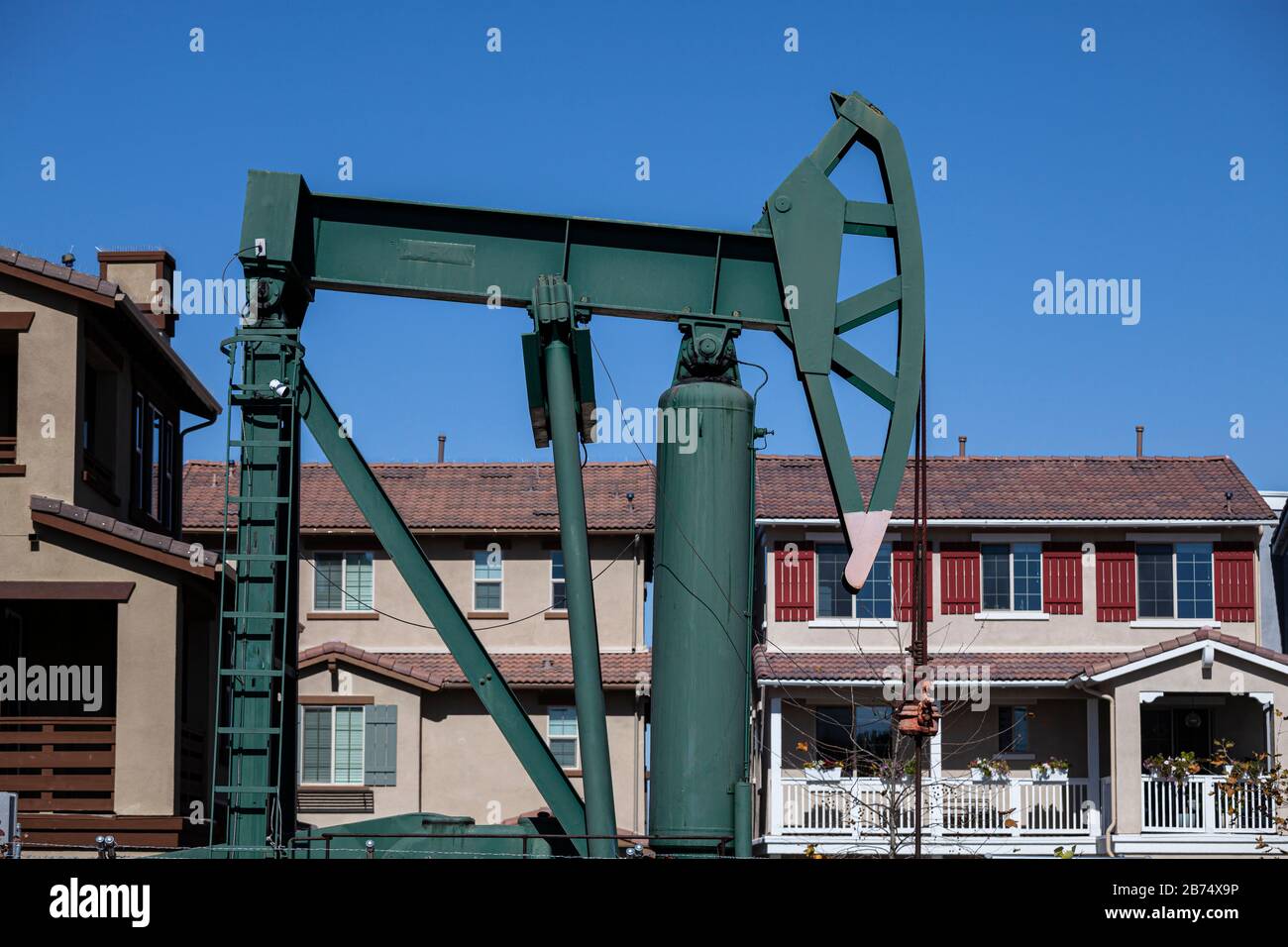 Oil well and pumpjacks near housing developments in the City of Signal