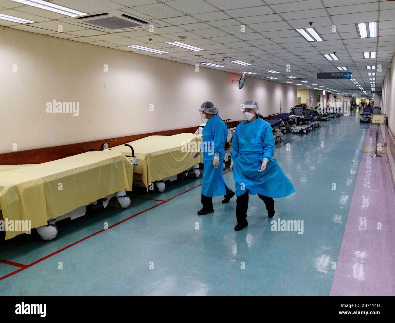 Medical staffs in protective gear walk inside Tuen Mun hospital. About 3000 medical staffs go on strike and threaten to escalate if the government does not close the border. Stock Photo