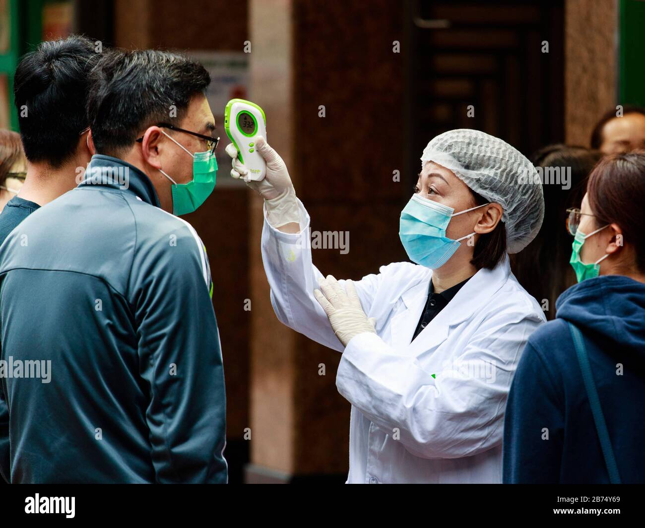A restaurant staff check body temperature of a client before entering the restaurant. The latest unemployment rate would very likely surpass the 3.3 per cent in the last quarter. Stock Photo