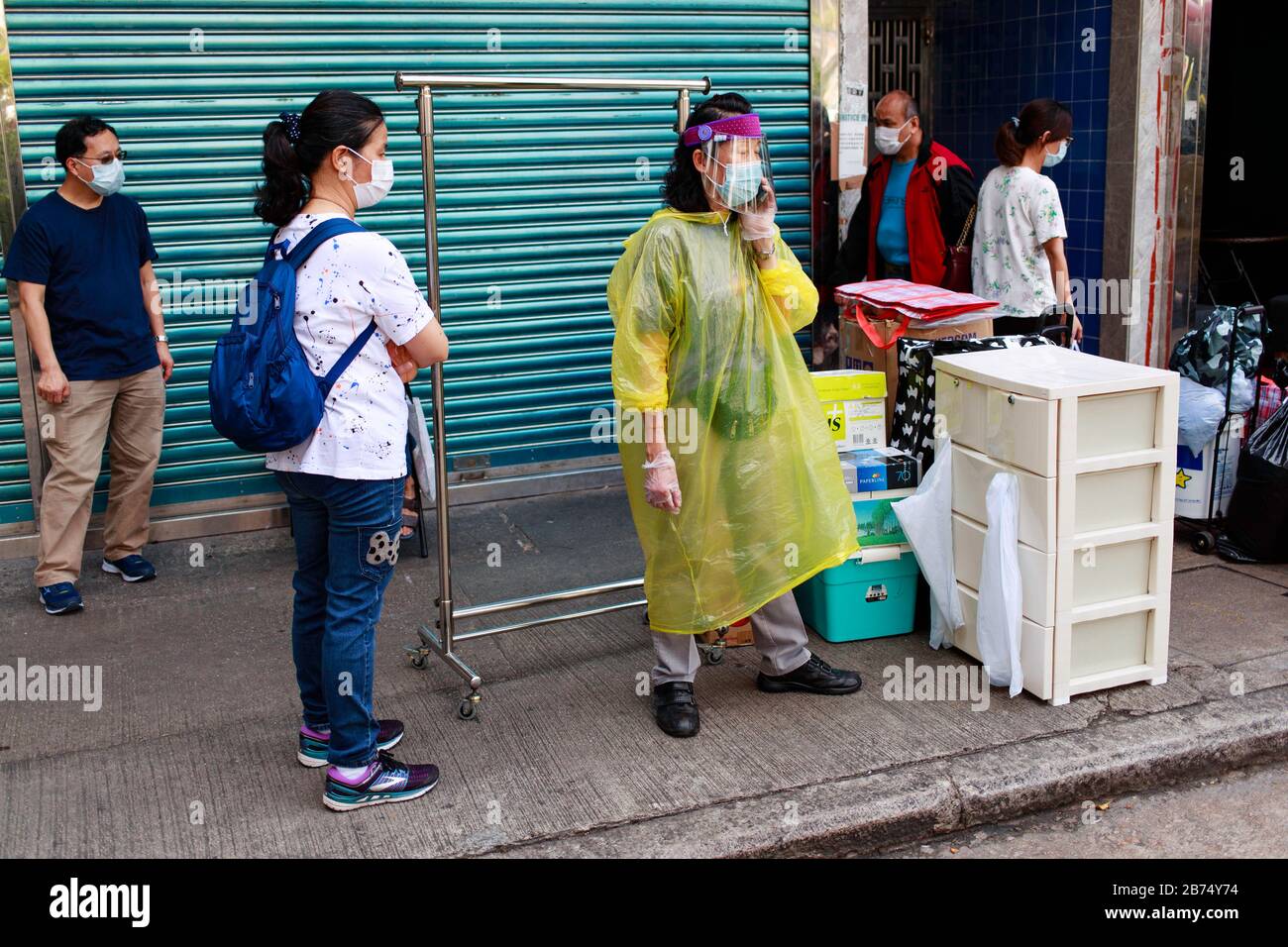 A woman in full gear uses her mobile phone on a street in Hong Hong. Stock Photo
