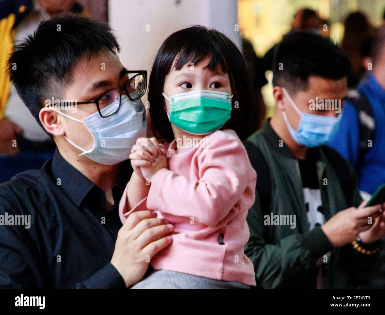 People wear surgical mask on the street as one mainland Chinese man