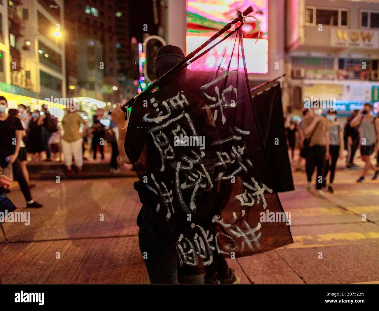 A protester carry a flag reads:'Protect Hong Kong, Get rid of Comunism'. Hongkongers protest on the street after the govenment issues an anti-mask law today. Stock Photo