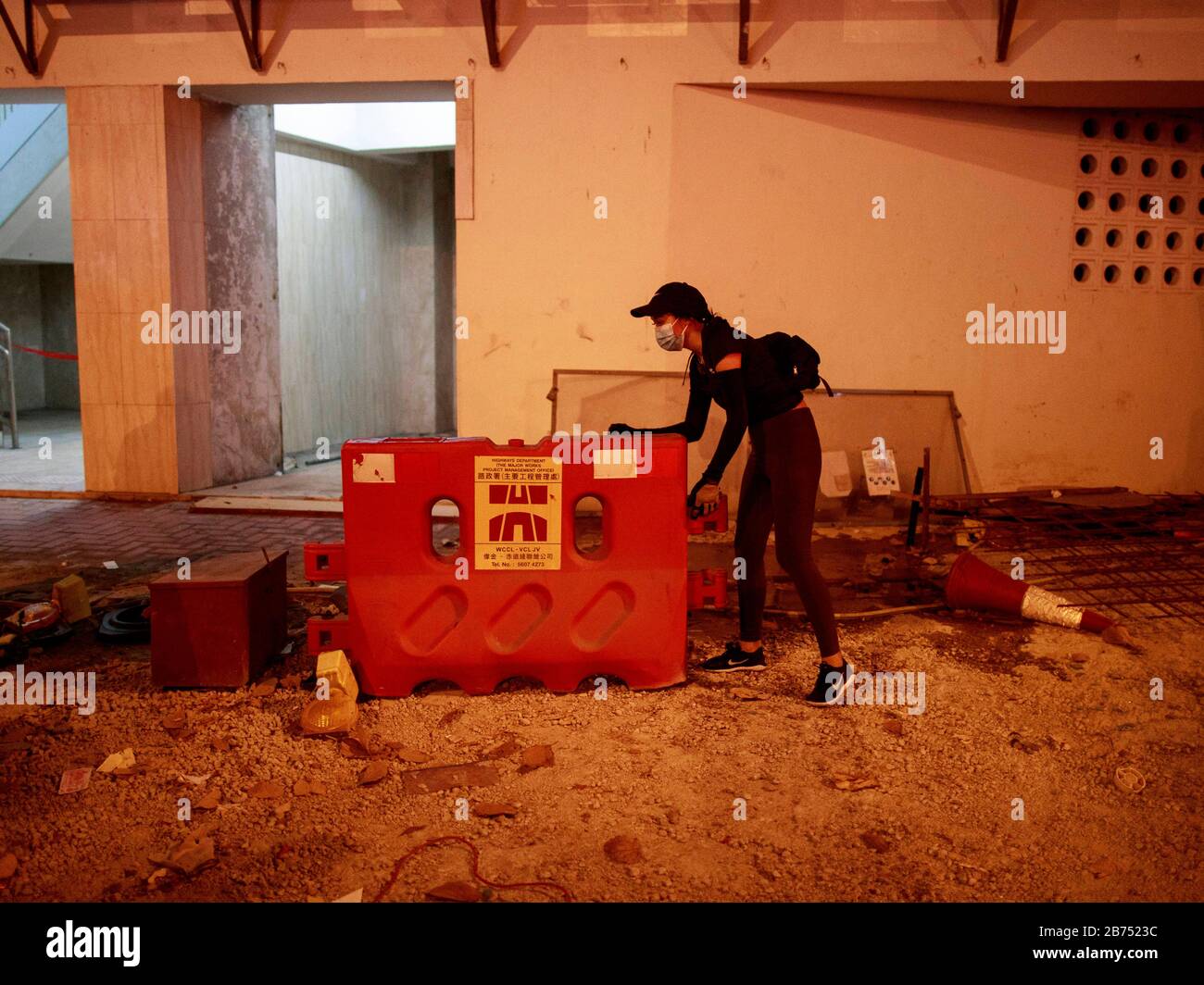 A protester build barricade after a rally. Hundreds of people gather to protest a high school student shot with live round by police yesterday 1 Oct 2019. Some protesters later set the gate of a police station on fire in Hong Kong. Stock Photo