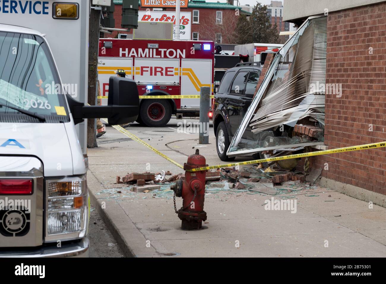 Car accident with fire and paramedic on scene to help victims. 911 emergency during the day time
