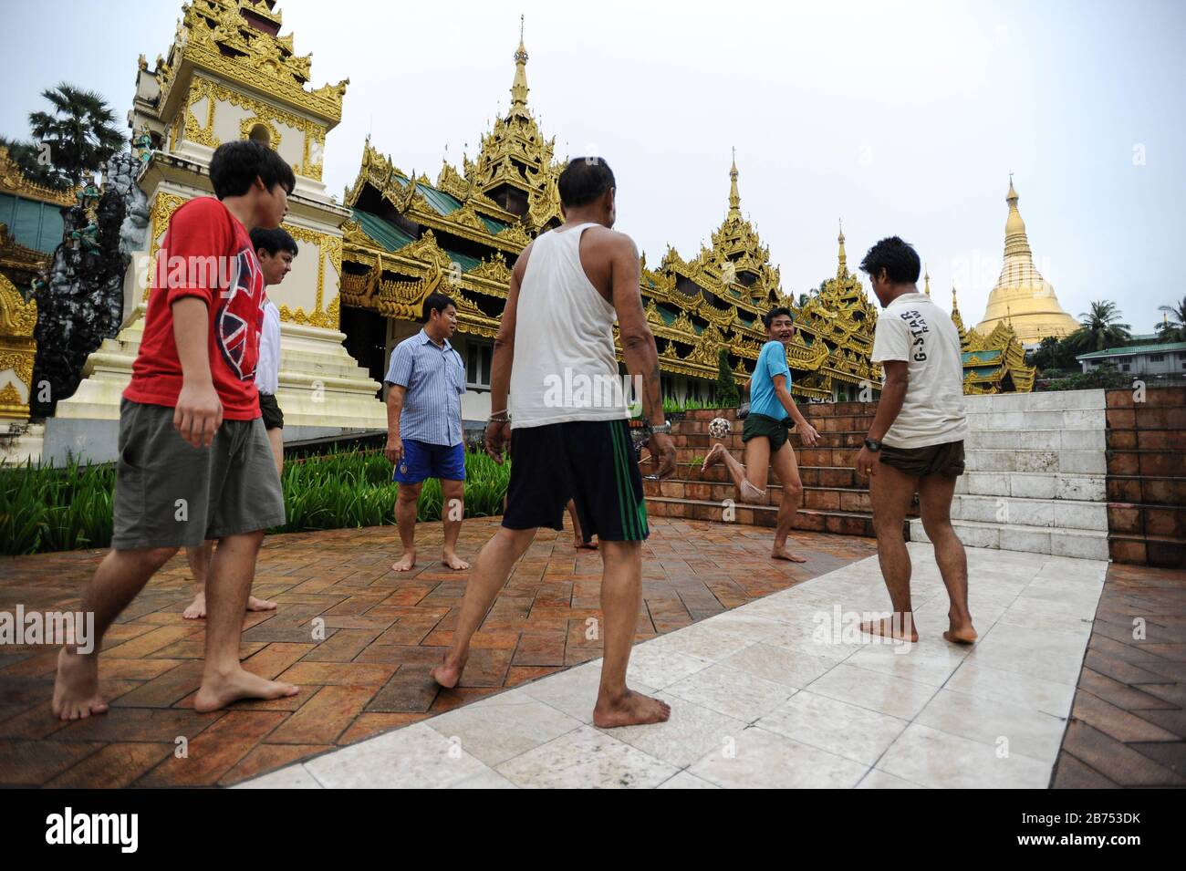25.08.2013, Yangon, Myanmar, Asia - A group of men play in front of the  temple area of the Shwedagon Pagoda Chinlone. The game is the national sport  of the South East Asian