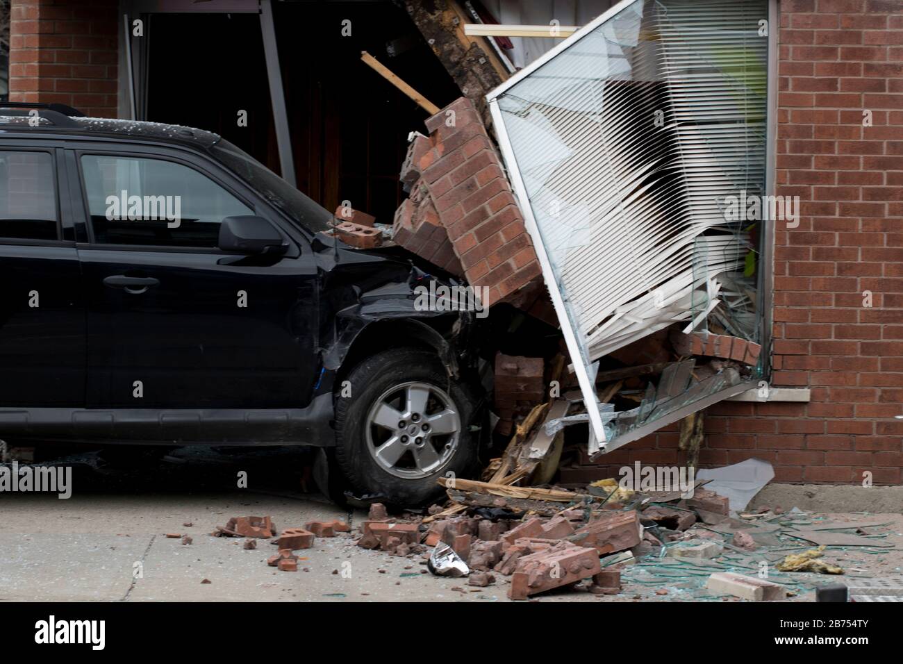 Car accident into brick building. Emergency response to vehicle crash