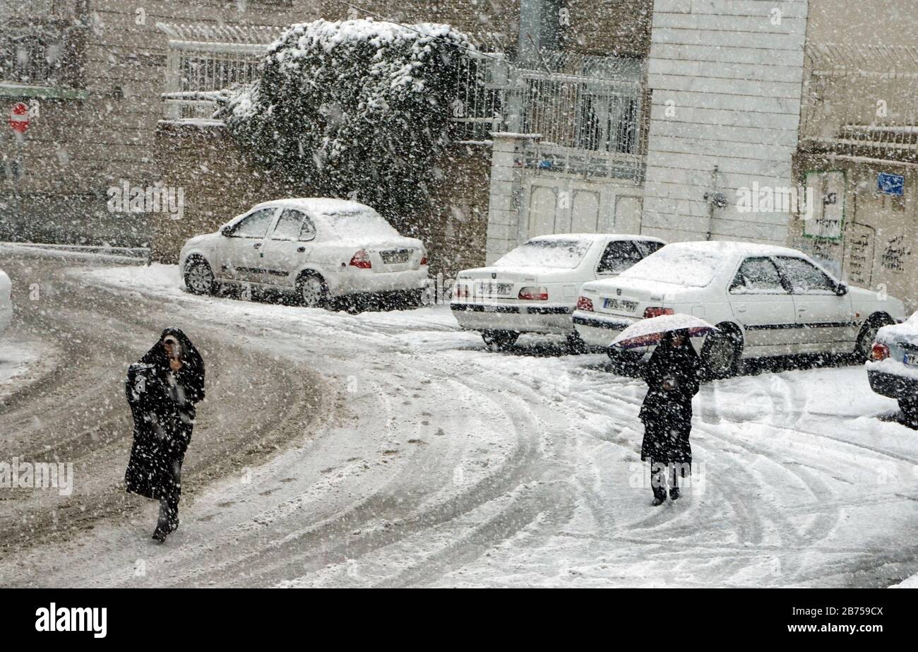 Heavy snowfall in Arak Iran women with chador and traditional