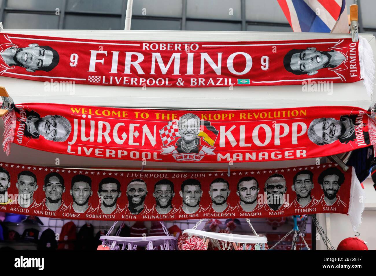 Scarves with Juergen Klopp photo, the coach of the FC Liverpool, and the slogan 'Welcome to the Klopp Revolution' are hanging on a FC Liverpool fan article shop in Liverpool, on 01.03.2019. [automated translation] Stock Photo