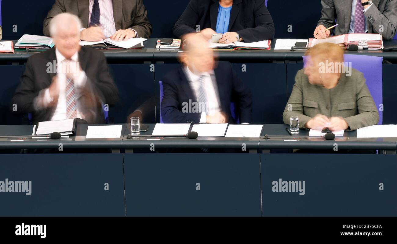 During A Debate In The Bundestag Chancellor Angela Merkel Cdu Right Finance Minister Olaf Scholz Spd Centre And Interior Minister Horst Seehofer Appear Blurred And Blurred On The Government Bench The Photo