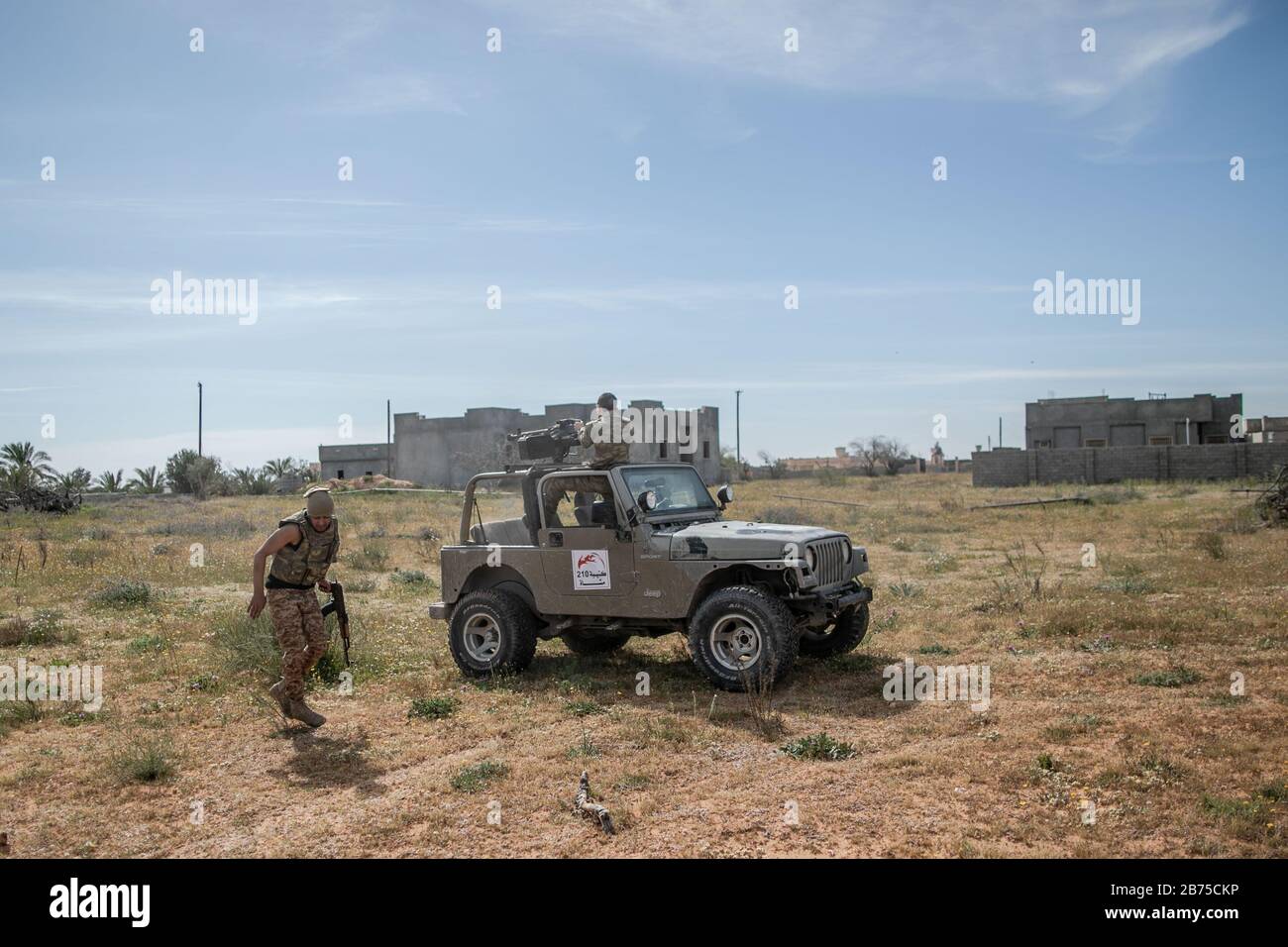 13 March 2020, Libya, Tripoli: A fighters of Libya's UN-backed Government of National Accord (GNA) of Fayez al-Sarraj, fires his truck-mounted heavy machine gun at the forces of the self-styled Libyan National Army (LNA) led by Libyan strongman Khalifa Haftar, at Ain Zara frontline, in the southern suburbs of capital Tripoli. Photo: Amru Salahuddien/dpa Stock Photo