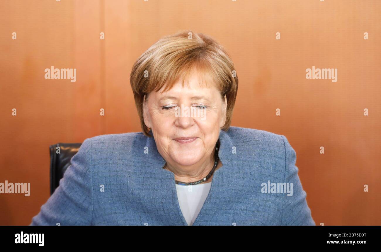 Chancellor Angela Merkel takes a seat at the cabinet table before the beginning of a cabinet meeting. Merkel is resigning as CDU party leader, and she does not want to extend her chancellorship either. [automated translation] Stock Photo