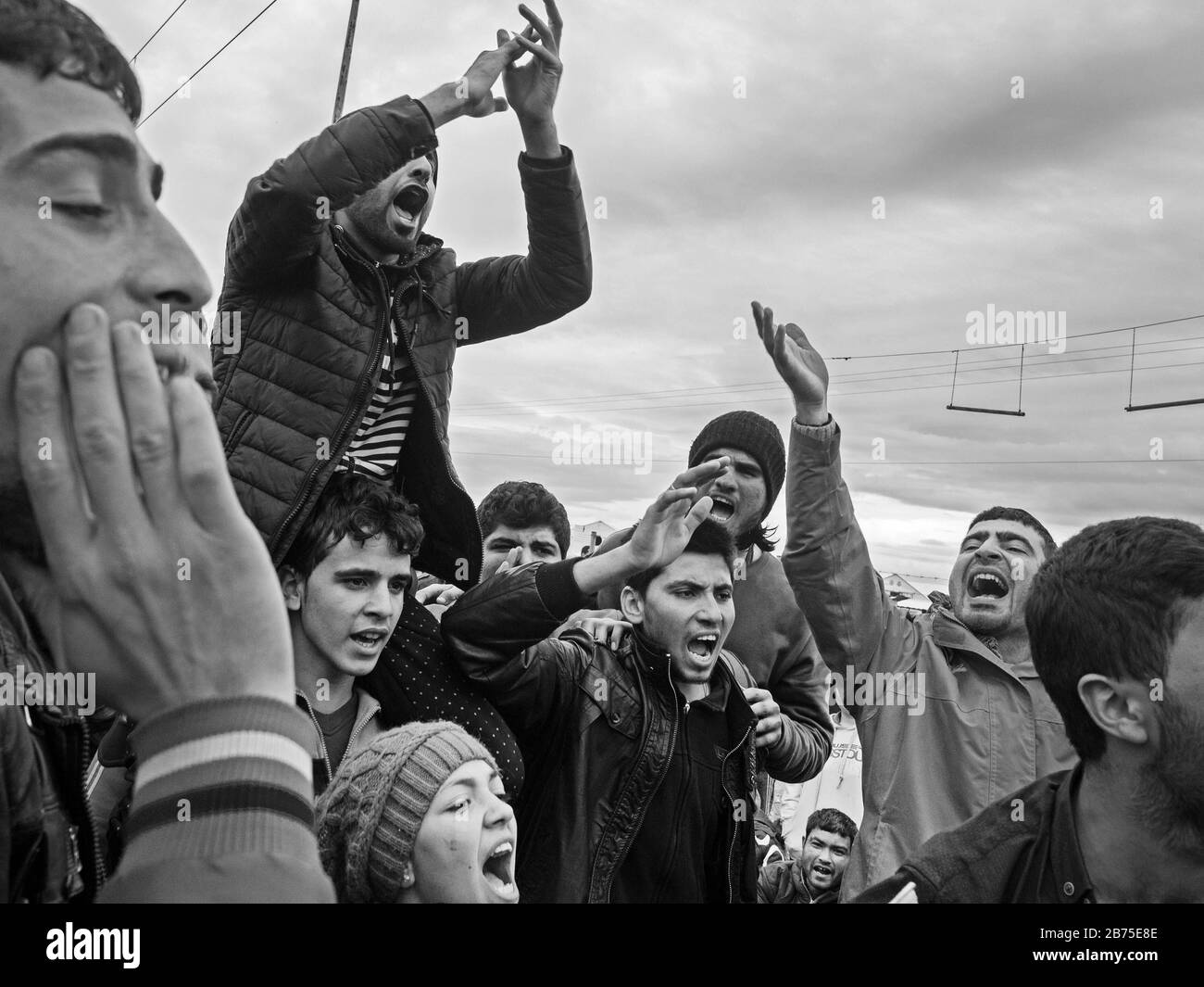 Refugee camp in Idomeni on the border with Macedonia. A group of young refugees demonstrate against the closure of the border. [automated translation] Stock Photo