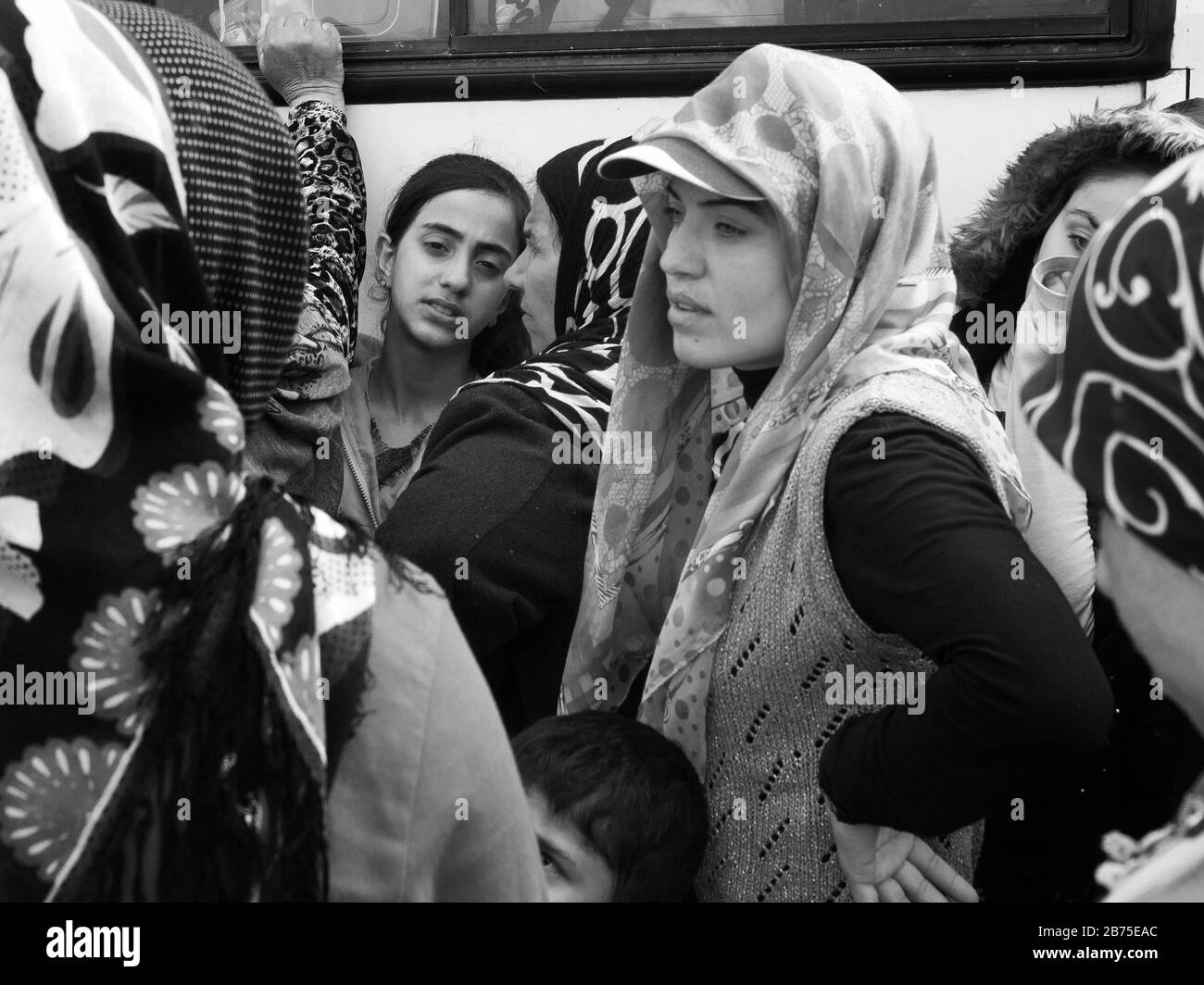 Refugee camp in Idomeni on the border with Macedonia. Women stand in line and wait for a meal from a private organisation. [automated translation] Stock Photo