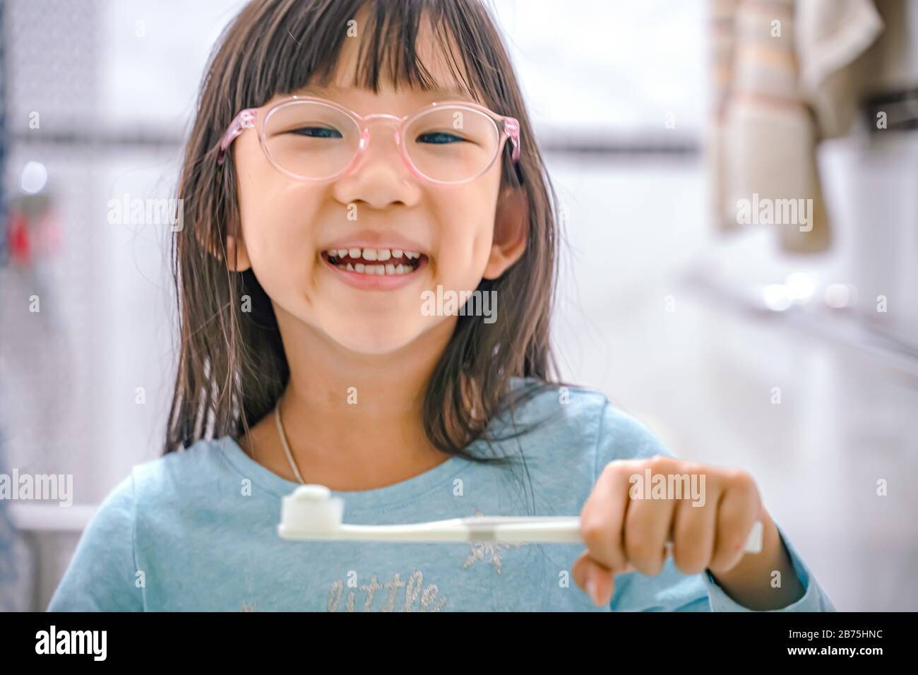 Little girl brushing teeth in bath.dental hygiene. happy little girl