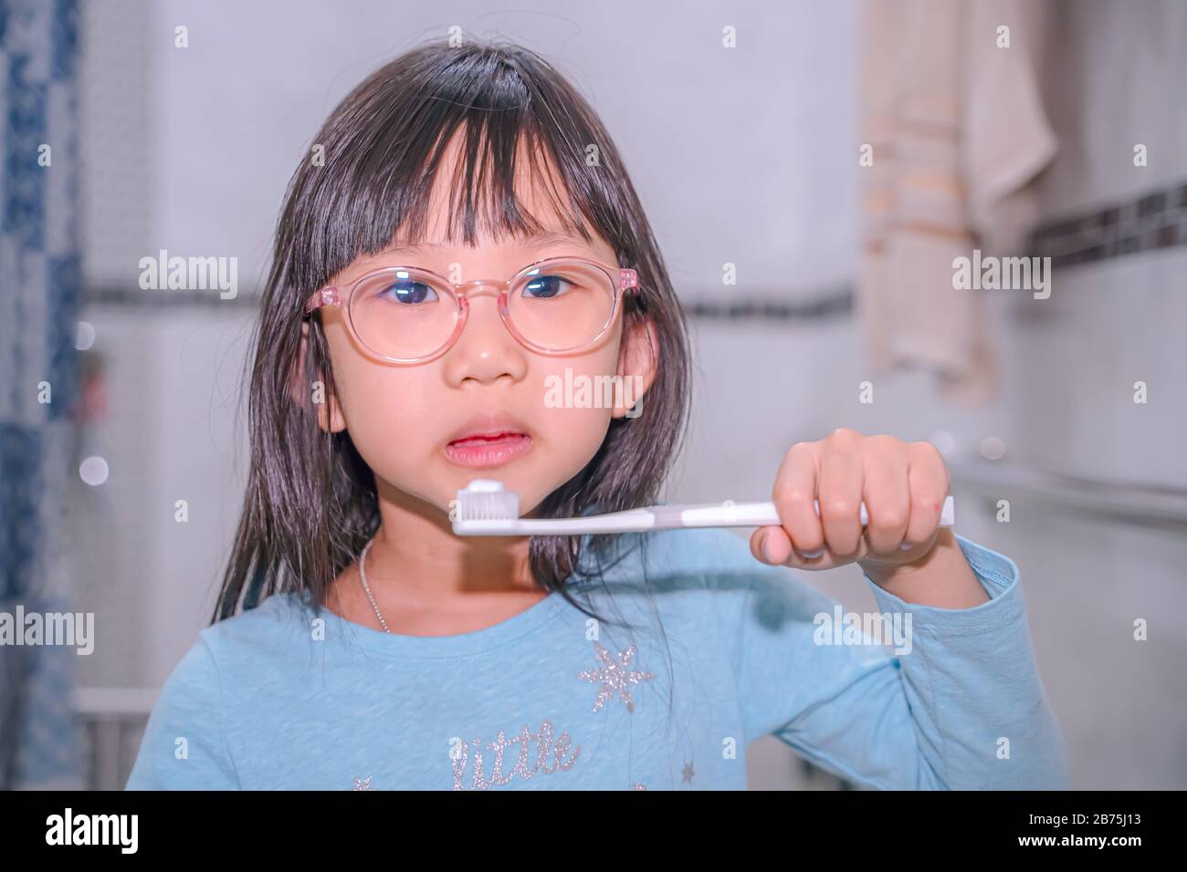 Little girl brushing teeth in bath.dental hygiene. happy little girl