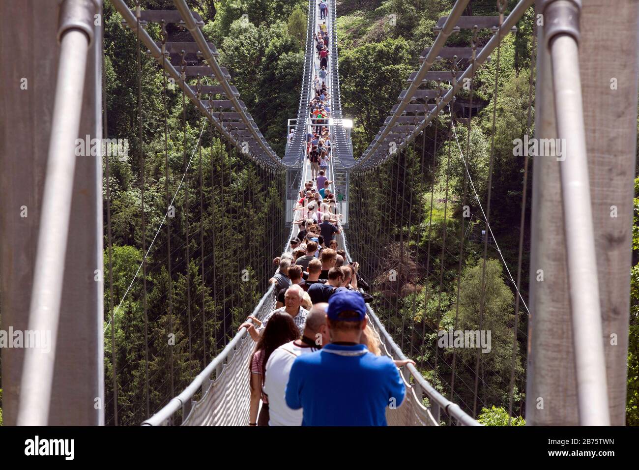 On 11.06.2017 visitors will walk over the rope suspension bridge at the Rappbode dam, 483 metres long, 100 metres above the valley floor. [automated translation] Stock Photo