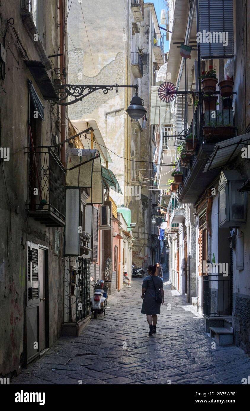 A woman walks through a street in the historical centre of Naples on 4 May 2017. [automated translation] Stock Photo
