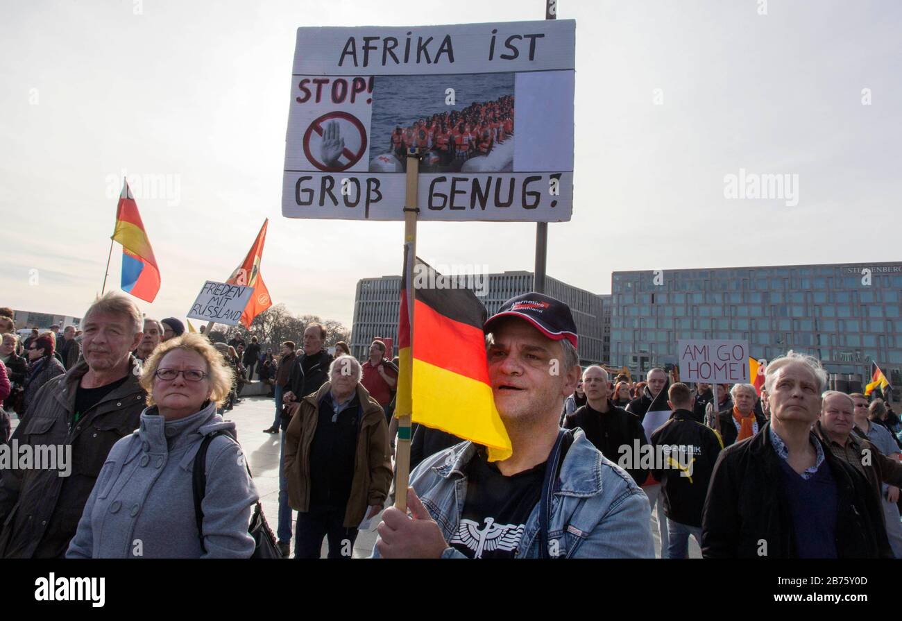 A participant of the 'Merkel must leave' demo is wearing an AFD cap and holding a sign saying 'Africa is big enough', a demonstration of right-wing populist and right-wing extremist participants, including supporters of the NPD, Pegida, Reich citizens, hooligans, compatriots and identities. [automated translation] Stock Photo