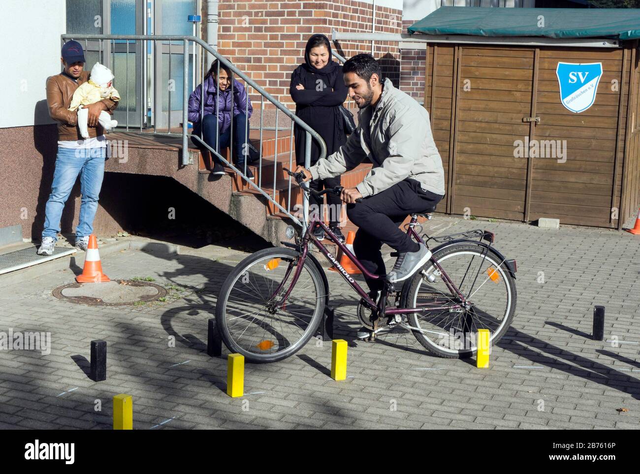 Syrian refugees will learn traffic rules and cycling during an integration course, on 05.10.2016. The Oberspreewald-Lausitz district and traffic guard will show and explain traffic signs and rules to the refugees in the rooms of the Grossraeschen sports club. [automated translation] Stock Photo