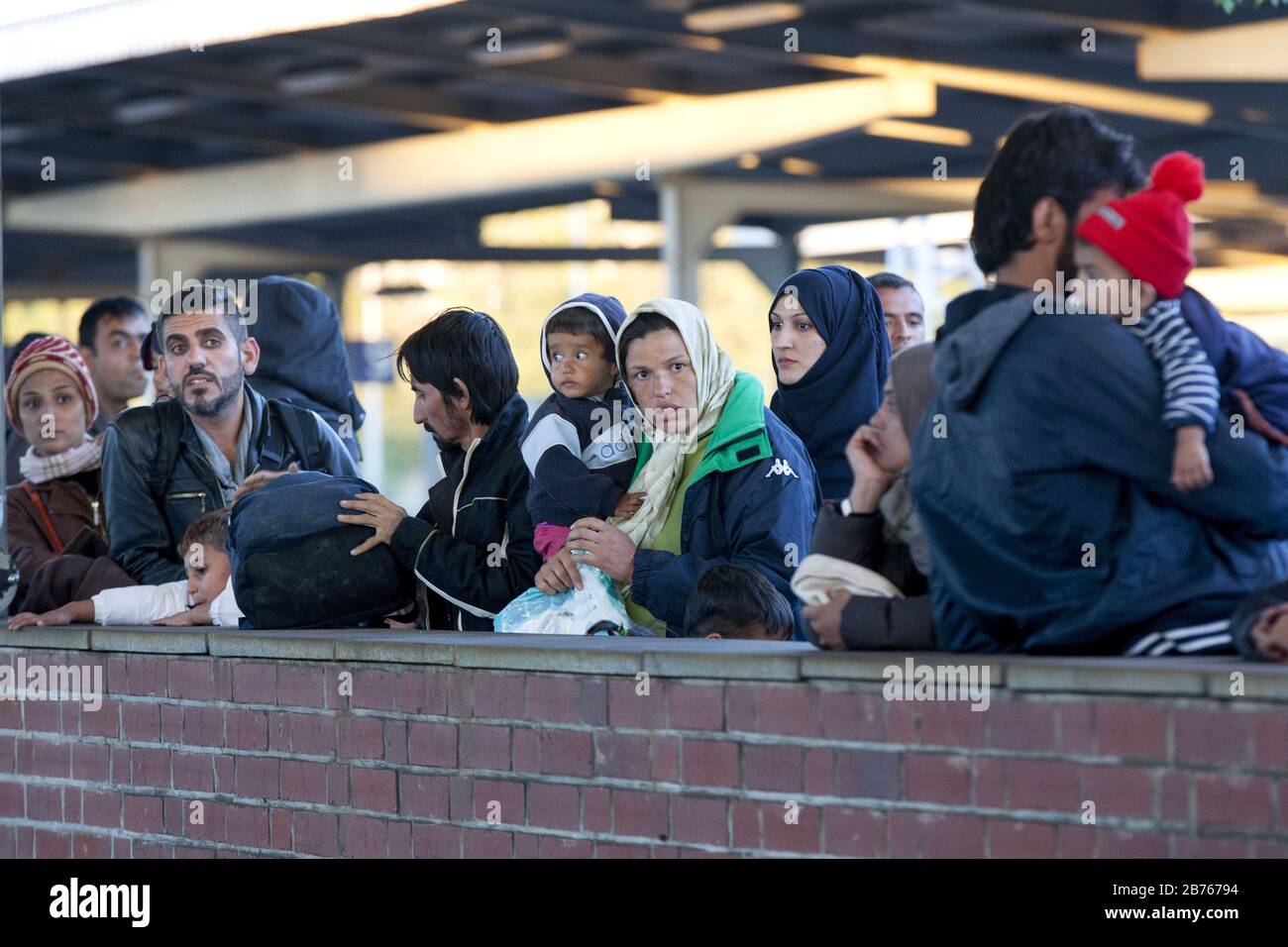 Refugees arrived at Schoenefeld station on 01.10.2015 by a special train. They will then be taken by bus to accommodation in Berlin. [automated translation] Stock Photo