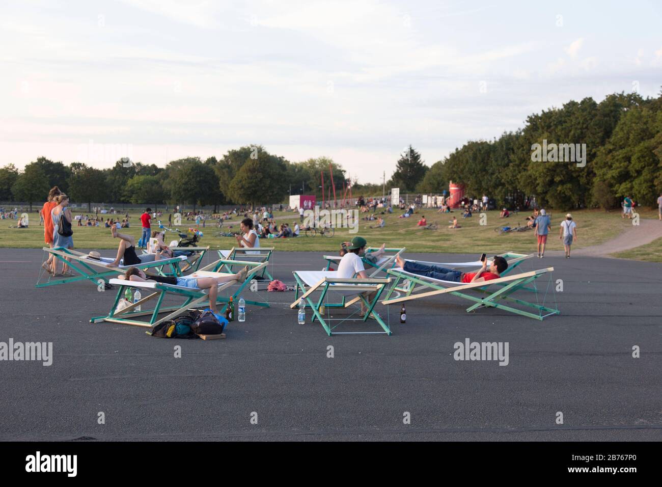 Visitors to Tempelhofer Feld relax on large deckchairs on 30 August 2015. The former Tempelhof Airport is well frequented as a leisure park during the summer months. An urban park landscape is developing on the former airport site. [automated translation] Stock Photo
