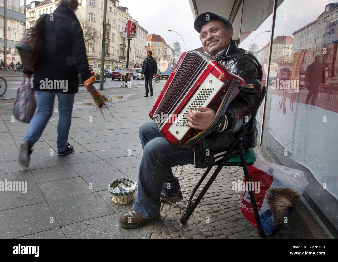 A street musician plays a piece of music with his accordion in the Berlin district Neukoelln on 27.03.2015. [automated translation] Stock Photo