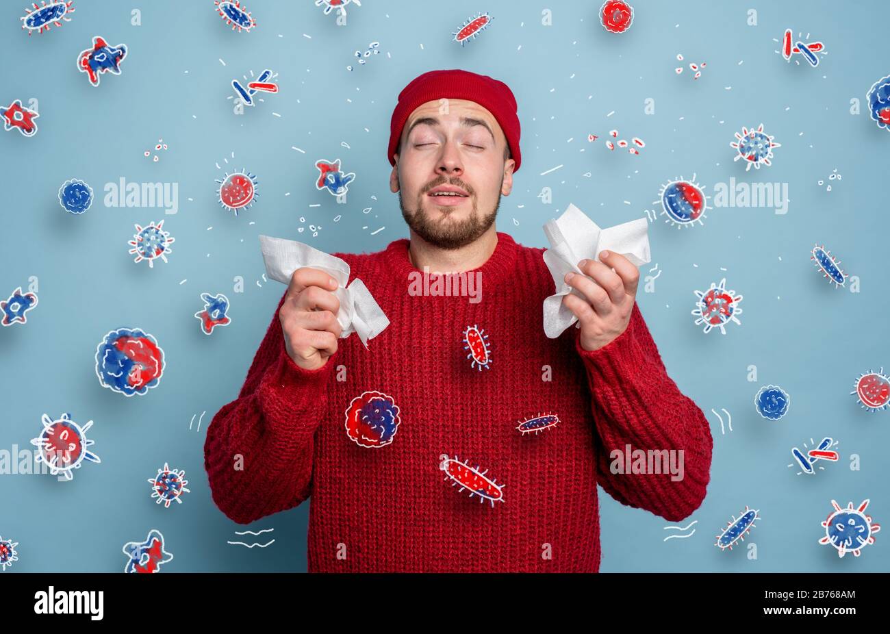 Boy caught a cold and is surrounded by viruses and bacteria. Studio on Cyan background Stock Photo