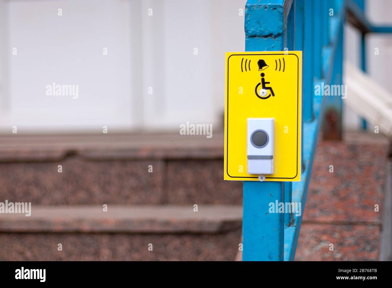 Bell button to call staff for disabled customers at pharmacy stairs Stock Photo