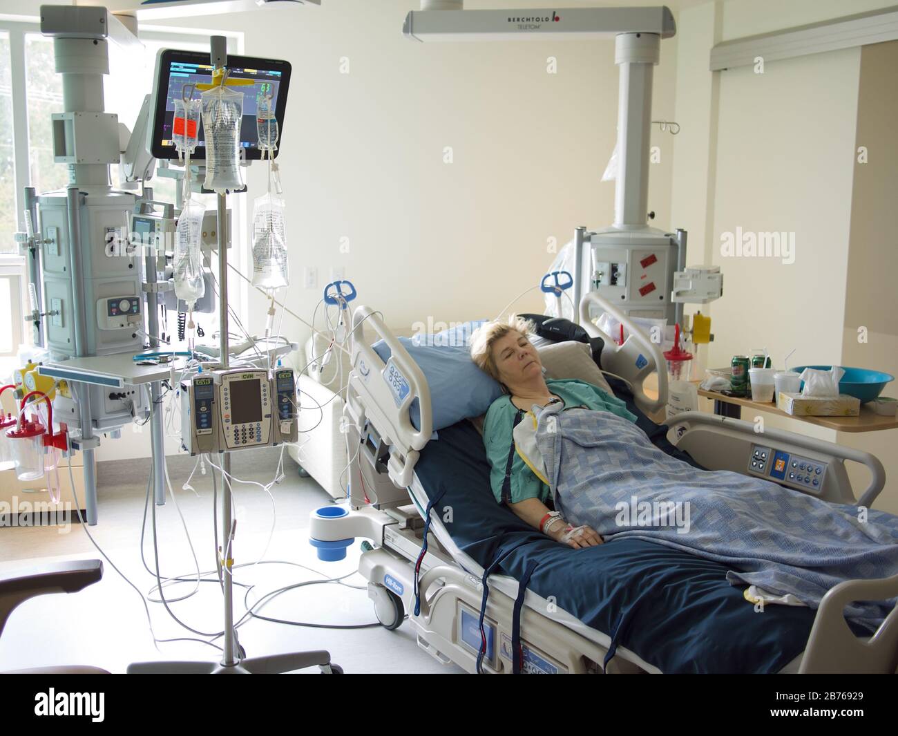 sick woman lying in hospital bed Stock Photo