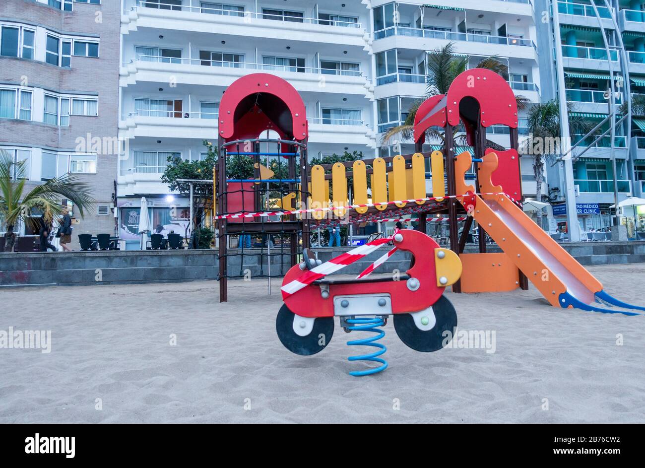 Las Palmas, Gran Canaria, Canary Islands, Spain. 13th March 2020. A beach playground is is taped off on the city beach in Las Palmas on Gran Canaria to prevent the spread of Coronavirus as the government delares a state of emergency as Coronavirus cases continue to rise in Spain. The Impact of travel restrictions and reduced number of tourists is a major concern for the Canary Islands. Credit: Alan Dawson/Alamy Live News Stock Photo