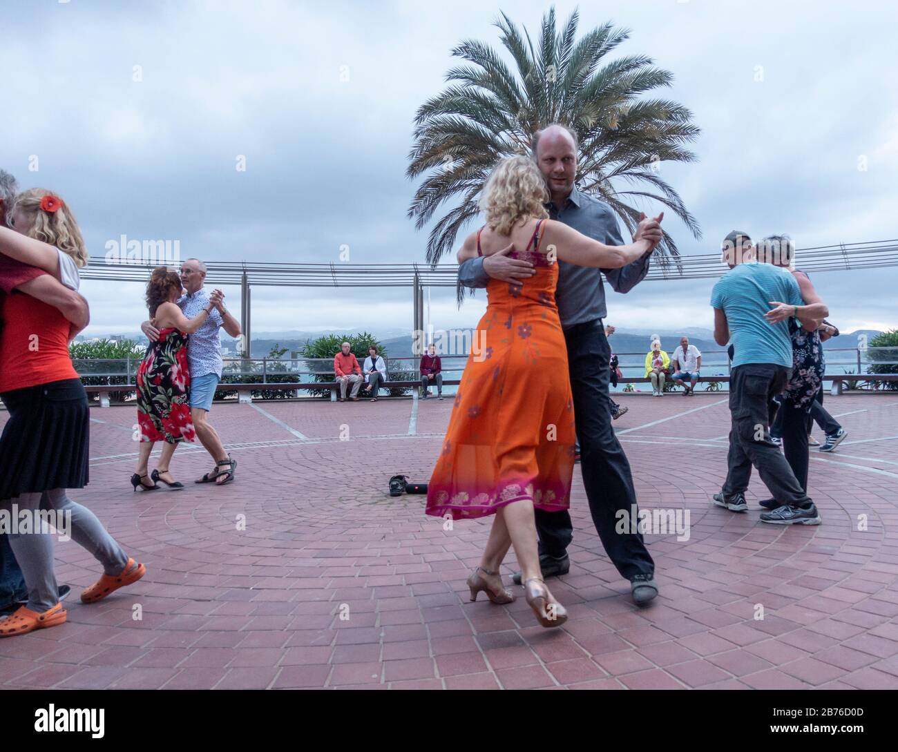 Las Palmas, Gran Canaria, Canary Islands, Spain. 13th March 2020. As the Spanish Prime Minister declares a state of emergency to combat the Coronavirus outbreak, dancers who are on Gran Canaria for an international Tango festival, which has been cancelled, dance on the seafront in Las Palmas on Gran Canaria at dusk. The Impact of travel restrictions and reduced number of tourists is a major concern for the local economy. Credit: Alan Dawson/Alamy Live News Stock Photo