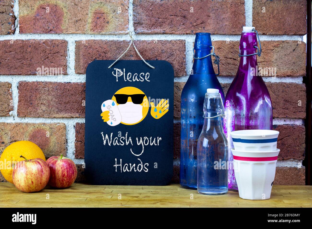 Cafe sign, please wash your hands with emoji  sticker washing hands with soap, coronavirus covid19 prevention Stock Photo